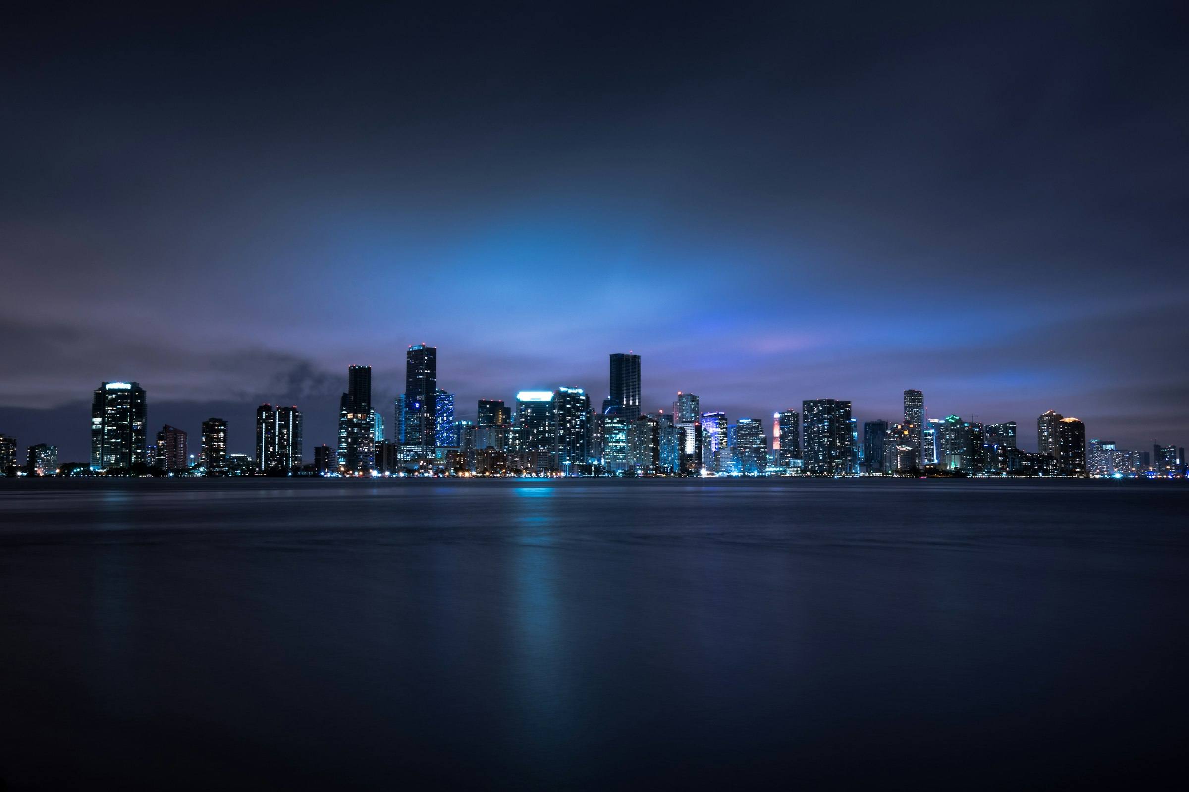 Miami skyline at night across the water
